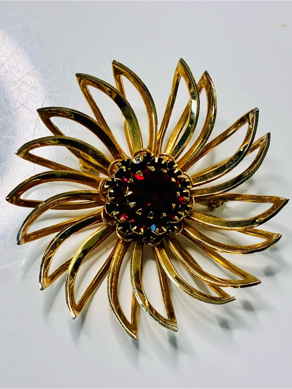 Sarah Coventry Gold-tone Sunburst Brooch with Deep Red Center